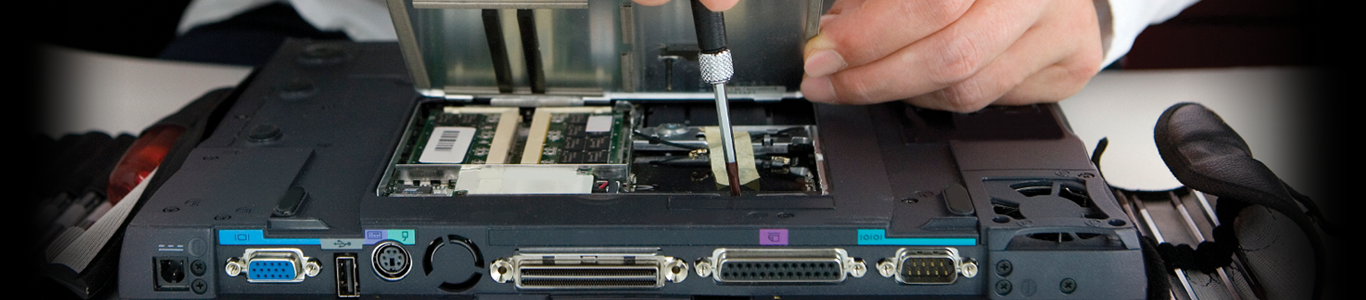 A technician working inside a laptop at the A.P. Computers repair bench