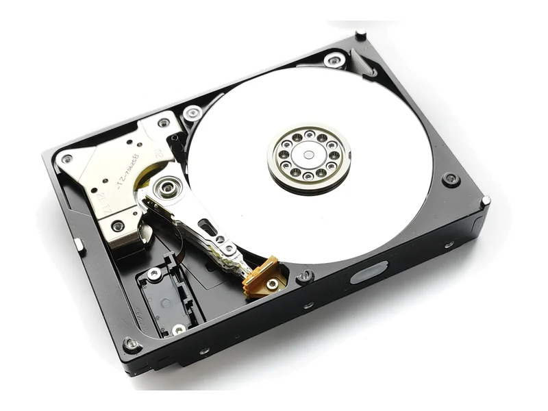 An opened hard drive showing the platter and read head